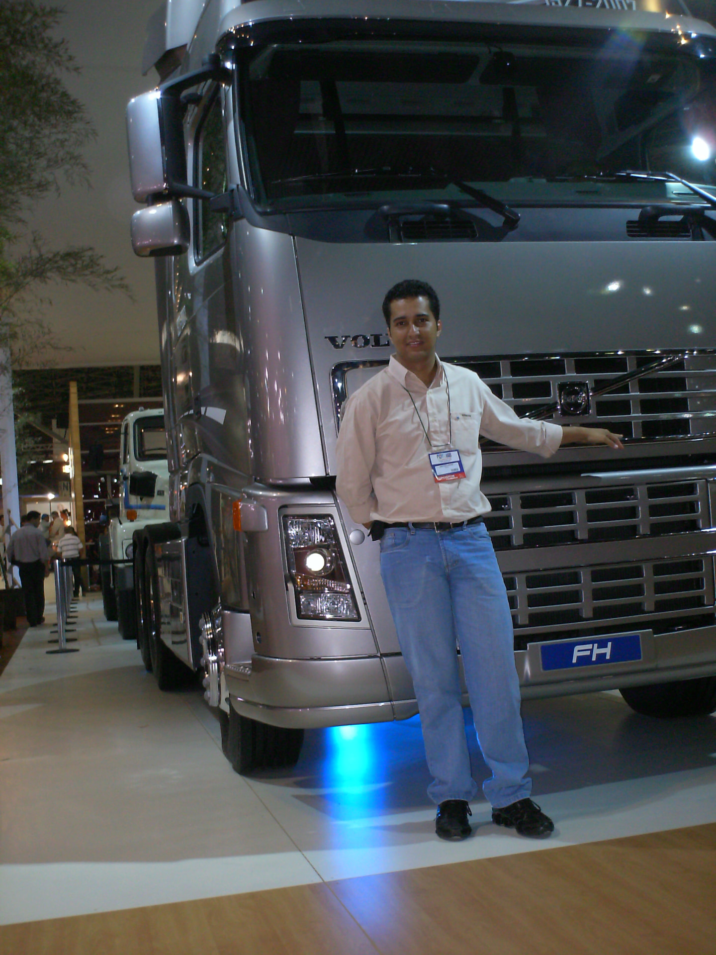 Jonathas em pé ao lado de um caminhão Volvo FH